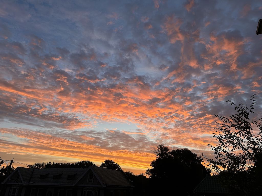Late summer morning sky in St. Louis, MO. Pink clouds over an old brick building.